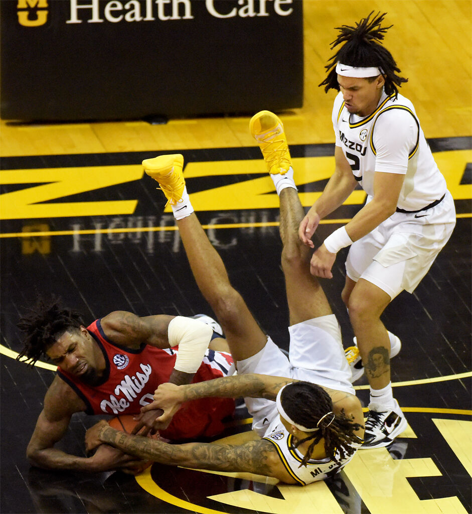 Romeo White, Mitchell Smith and Drew Buggs wrestle for the ball